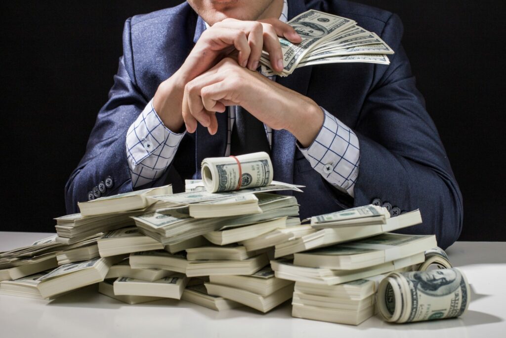 Man holding Money in hand at Black Background,