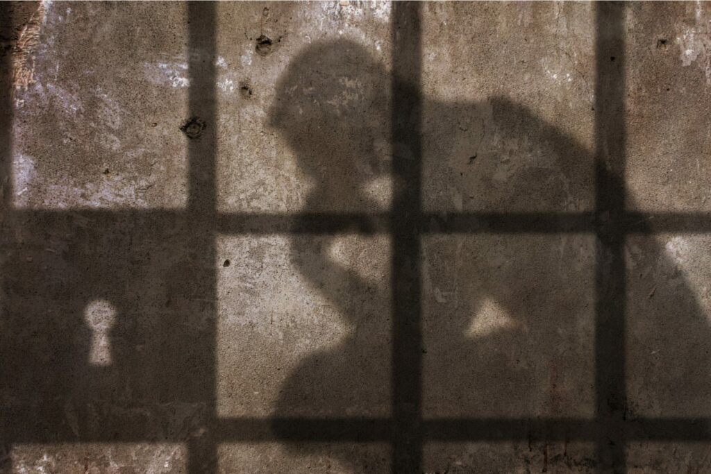 Thinking man Shadow Under Jail Bars.