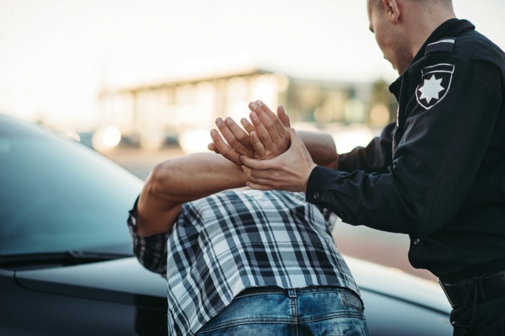 Police officer arrests the driver violator on road